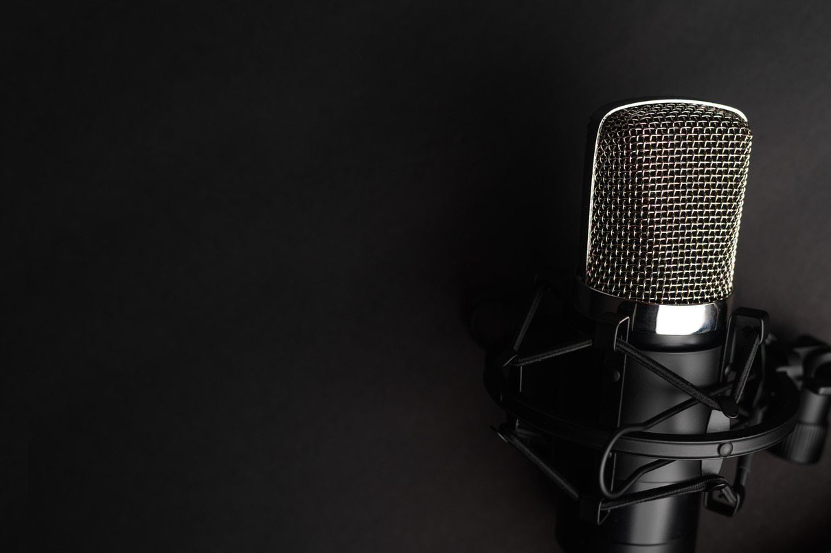 Condenser black studio microphone on a black background. Streamer, podcasts, music background